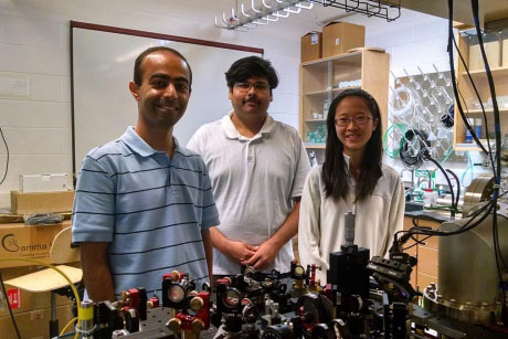 Mukund Vengalattore, left, Yogesh Patil and Laura Chang '15 in the Ultracold Atomic Physics Lab in Clark Hall