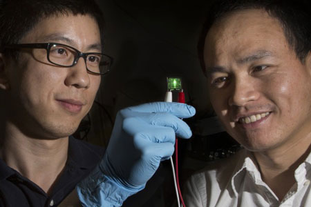 Assistant Professor of Physics Hanwei Gao and Associate Professor of Chemical Engineering Biwu Ma examine their LED material