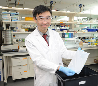 Associate Professor Tong Yen Wah holding up a sample of the novel biomimetic membrane