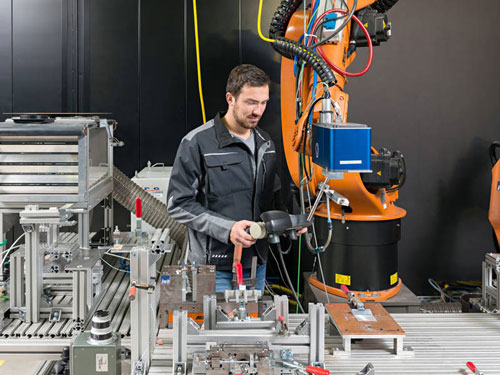 André Heckert is working with a laser to fuse plastics with metals
