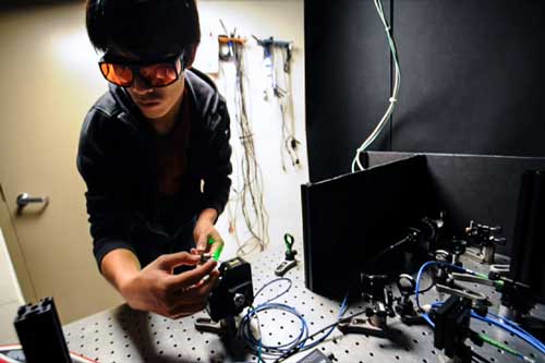 Masashi Hirose adjusts optical components