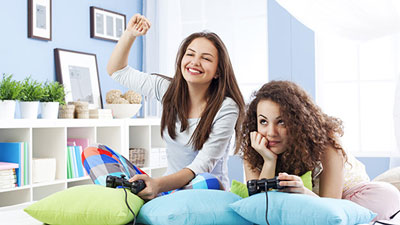 Photo of a 2 women playing video games