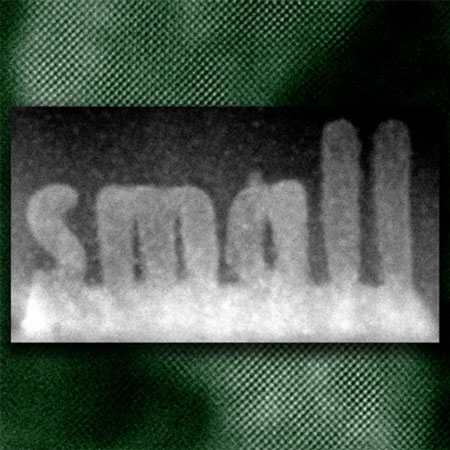 crystallized oxide (lighter regions) spelling the word 'small' was 'printed' on a non-crystallized layer