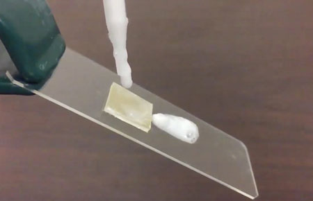 a drop of shampoo slides off a piece of polypropylene