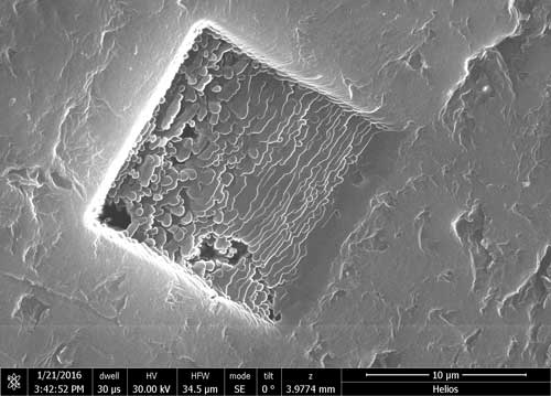 A focused ion beam microscope image shows 3-D graphene layers welded together in a block