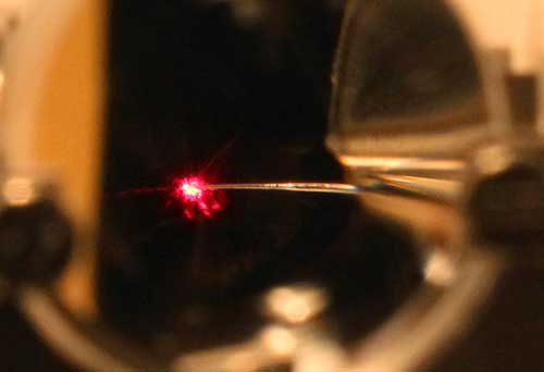 a laser beam strikes a nanotip