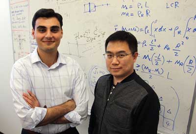 Dr. Fan Zhang (right), assistant professor of physics, and senior physics student Armin Khamoshi