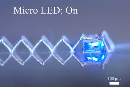 Manufactured 3-D electronic interconnects light an LED