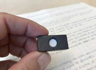 A small domino-sized cartridge holds a membrane for a new field test for liver cancer