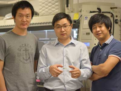Cunjiang Yu, Bill D. Cook Assistant Professor of mechanical engineering, center, and Xu Wang, left, and Kyoseung Sim, right