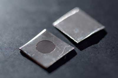 Close-up image shows an untreated stainless steel sample (left), and a sample that has been electrochemically treated to create a nanotextured surface