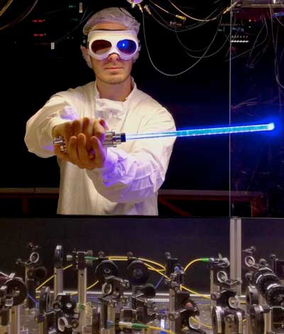 Nicolas Tolazzi holding a toy light saber in front of the experiment
