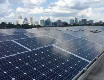 Rows of photovoltaic panels are shown atop a building on the Georgia Institute of Technology campus in Atlanta