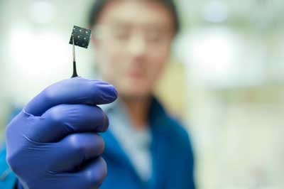 researcher holding a Perovskite-CIGS Tandem Solar Cell