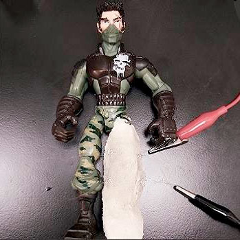 The leg of the action figure was coated in a strain-sensing artificial skin to demonstrate the material in action