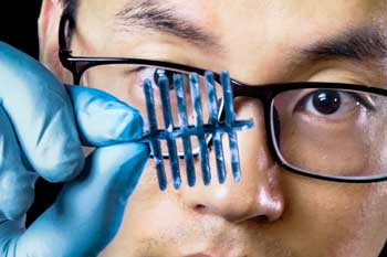 Shaobo Han with a sensor made from nanocellulose fibers