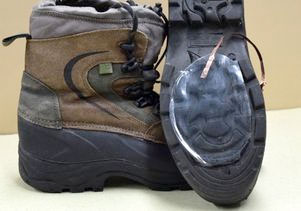 Hiking shoe with nanogenerator device attached to sole