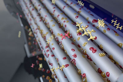 Artistic rendition of a dropwise condensing shell and tube heat exchanger, where vapor molecules condense onto heat exchange tubes and form drops that shed from the surface