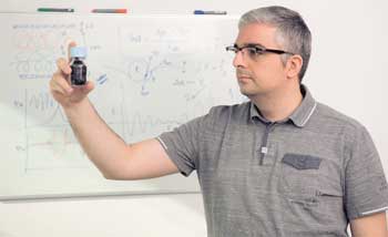 Ali Gooneie looks at a sample