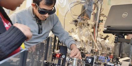 University of Kansas graduate student Tika Kafle (facing camera) working on the time-resolved photoemission spectroscopy setup
