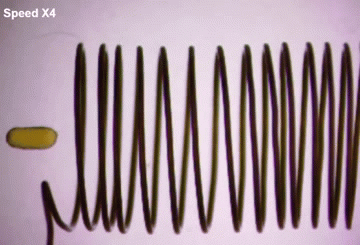 magnetic coil pulls iron-oxide nanoparticles toward it