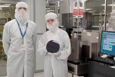 MIT researchers Anthony Ratkovich, left, and Mindy D. Bishop, who is holding an example of a silicon wafer