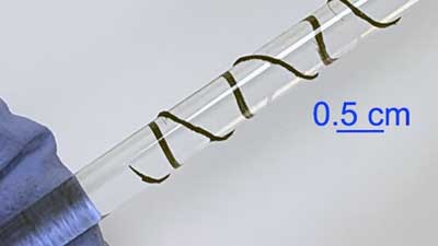 carbon nanotube film is twisted into a filament yarn and wound around a tube