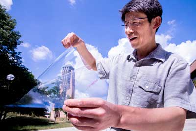 Jay Guo holds a sheet of flexible transparent conductor