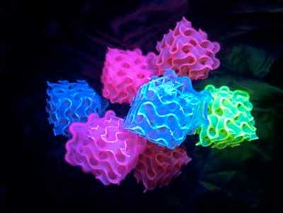 Stack of 3D printed gyroids glowing in the dark from the bright SMILES materials