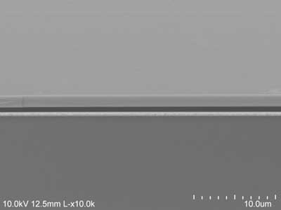 The electron microscope image shows the air (darkest gray) sandwiched between the gold backing at the bottom and the semiconductor at the top