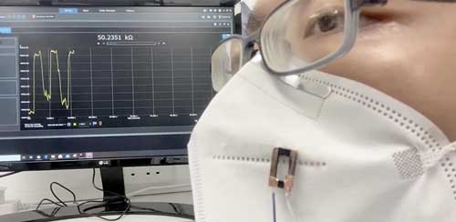 Fibre sensor attached to a face covering detects human breath with high sensitivity and responsiveness