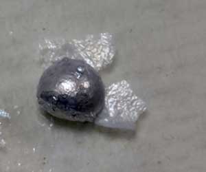 liquid metal droplet with flakes of aluminium oxide compounds grown on its surface