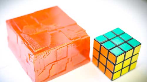 Perovskites crystal next to Rubik's cube