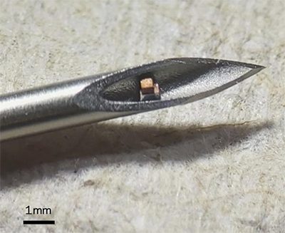 electronic circuit chip shown in the tip of a hypodermic needle