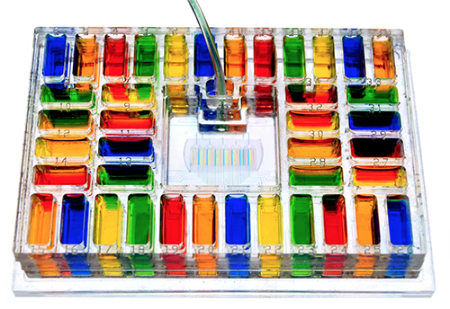 A device covered in wells of multicolored liquids