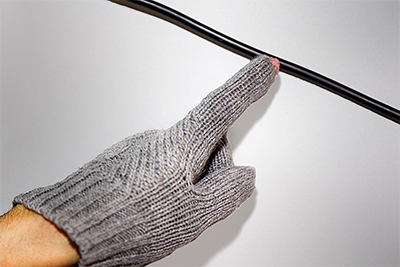 The fingertips of a wireless voltage detection glove