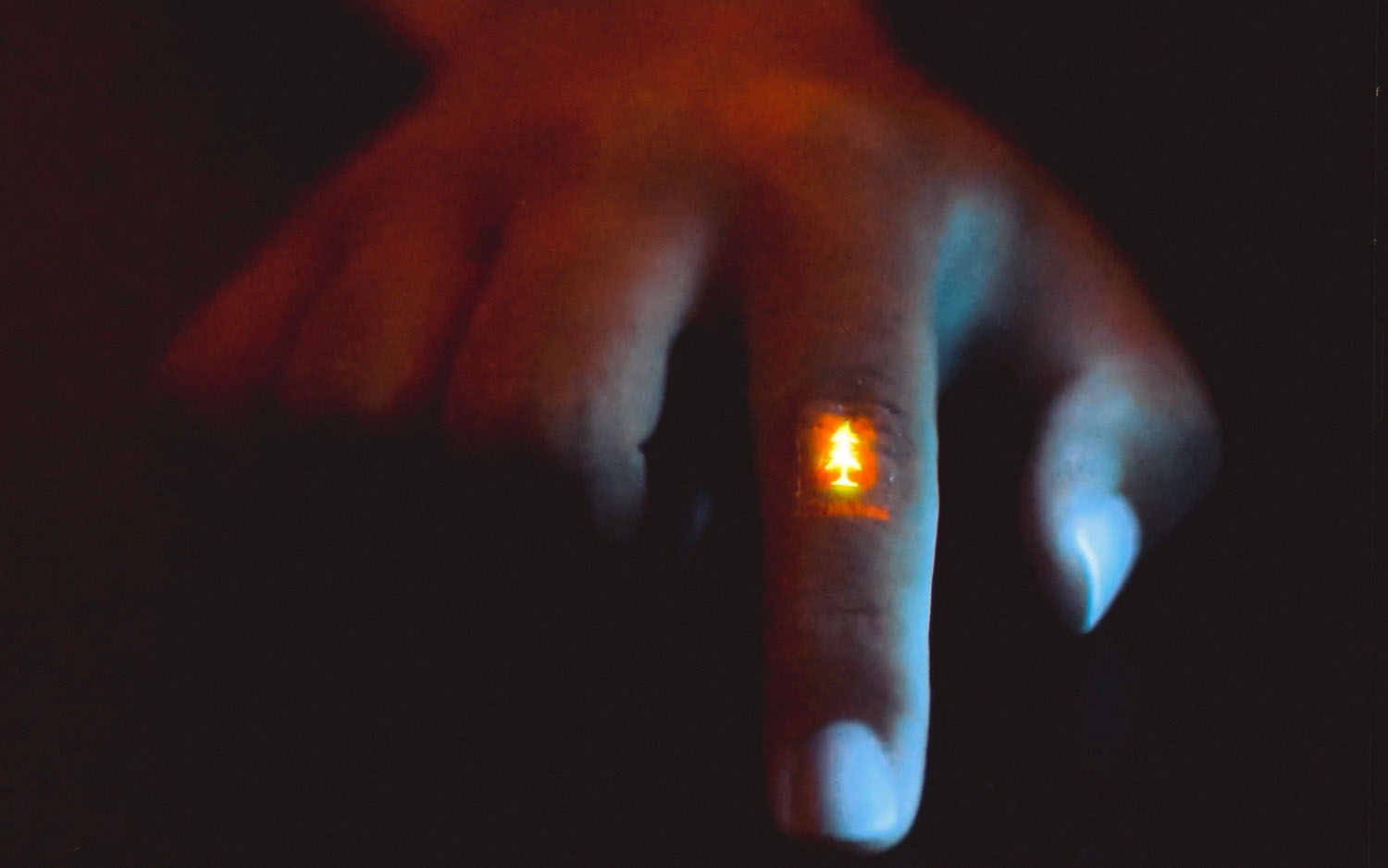 flexible light-emitting film on the knuckle of a finger