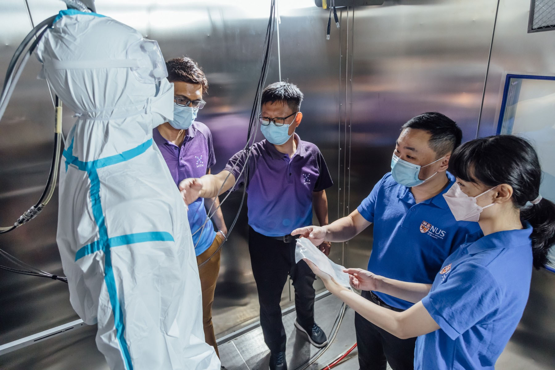 Attaching moisture-trapping film to a protective suit
