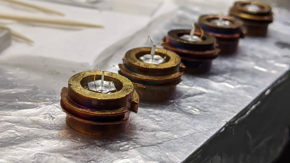 Image of doped CeCoIn5 samples resting on copper 'puck' sample holders