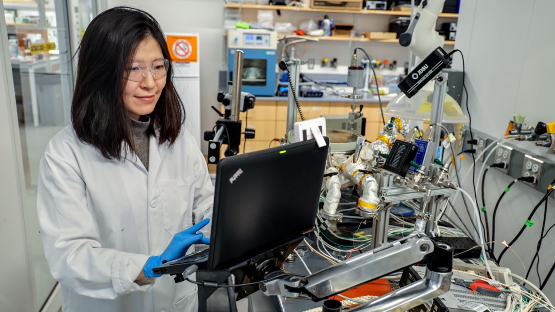 Rong Yang, assistant professor of chemical and biomolecular engineering, works with an initiated chemical vapor deposition system