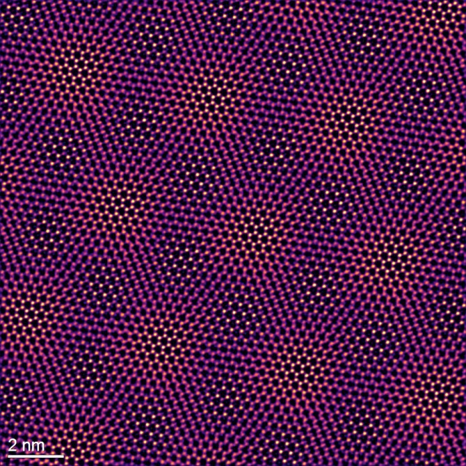 A transmission electron microscope image shows the moiré lattice of molybdenum ditelluride and tungsten diselenide.
