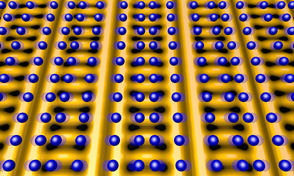 This image shows the positions of atoms (blue spheres) that make up the crystal lattice of a copper-oxide superconductor, superimposed on a map of electronic charge distribution (yellow is high charge density, dark spots are low) in charge-ordered states