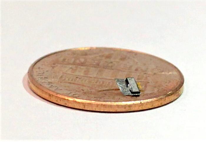 magnetoelectric material device on a penny for size comparison