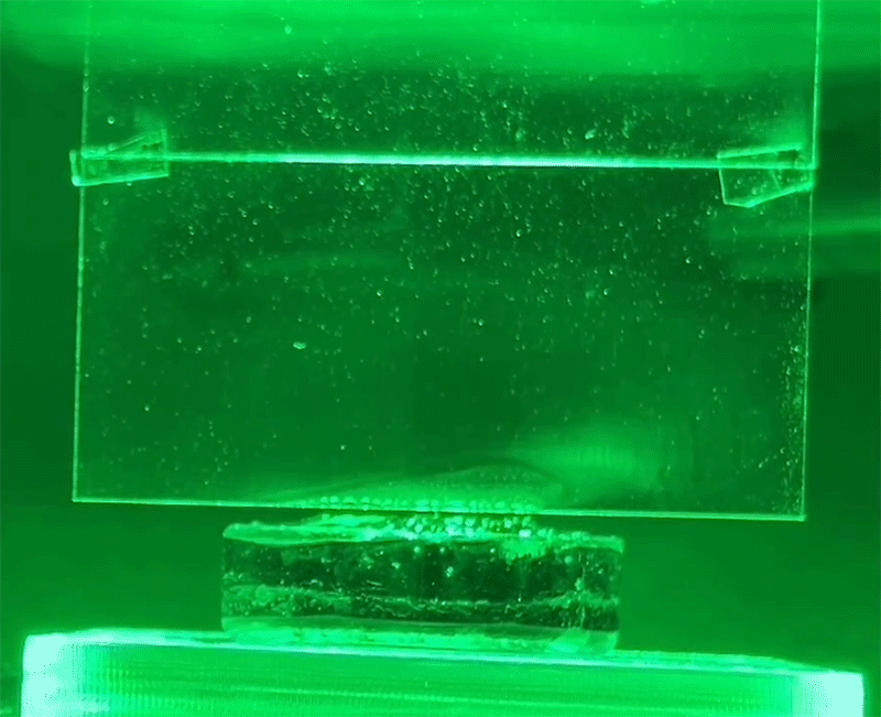 Animation shows evaporating by white condensation on glass under green light