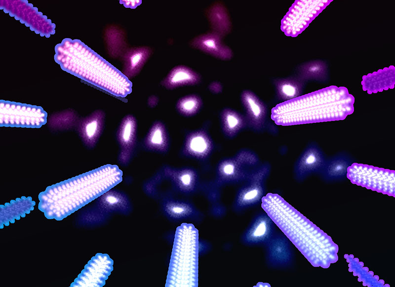 Patterned electron probes yield an extra level of precision in measuring tungsten diselenide lattice parameters. The complex-shaped electron probe is depicted in the background, and exaggerated changes in experimentally observed diffraction peaks due to temperature-induced lattice expansion are depicted in the foreground.