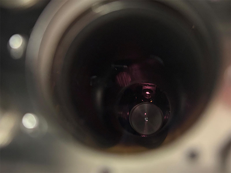 Laboratory setup for using giant “Rydberg” atoms to measure temperature. The glowing red orb shows the cloud of approximately one million rubidium atoms used in the setup