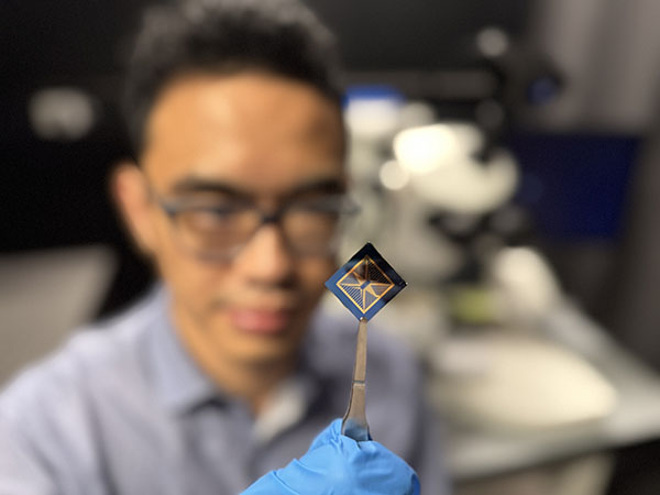 Thiha Aung inspects a neuromorphic vision device