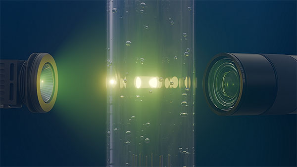 High-speed cameras capture swarms of bubbles rising through an LED-illuminated water column, revealing the chaotic flow patterns of bubble-induced turbulence