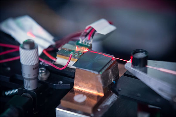 Ultra low noise injection locked laser using a 17 meter long coil resonator fabricated on a silicon nitride chip