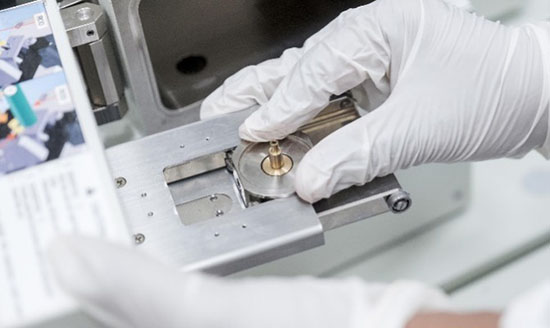 Graphite on a sample holder being loaded into a field emission scanning electron microscope